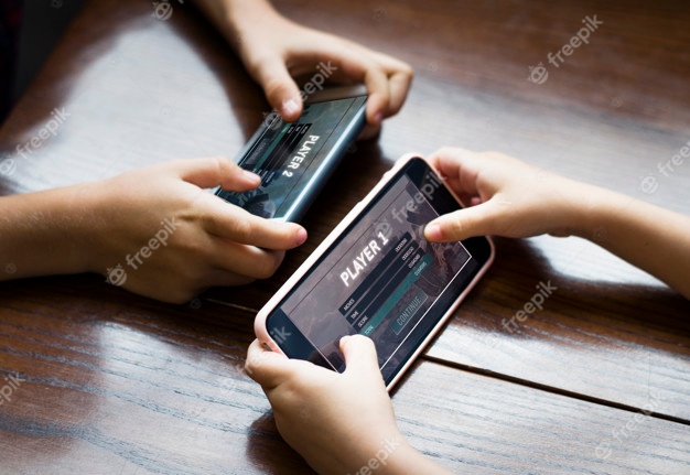 Little boy playing a mobile game against his sister Free Psd